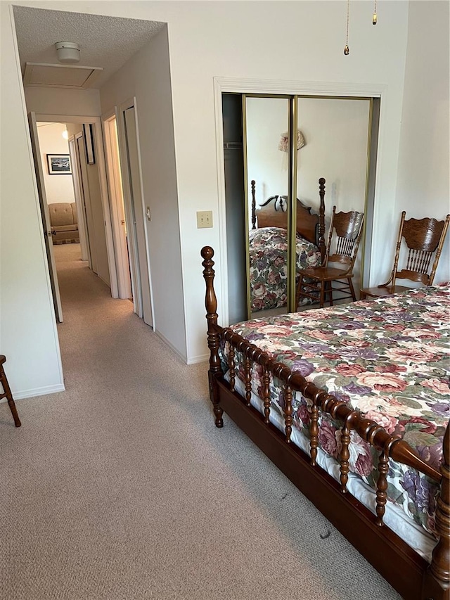 7616 Colonial Ct, Tampa, FL 33615 - bedroom featuring carpet floors, a closet, baseboards, a textured ceiling, and attic access