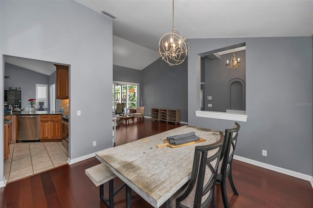 4133 Auston Way, Palm Harbor, FL 34685 - dining area with a chandelier, vaulted ceiling, light wood-style flooring, and baseboards