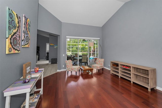 4133 Auston Way, Palm Harbor, FL 34685 - living area featuring vaulted ceiling, wood finished floors, and baseboards