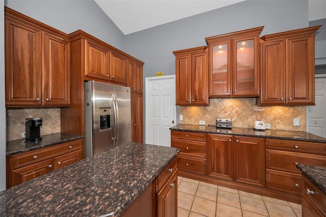 4133 Auston Way, Palm Harbor, FL 34685 - kitchen with stainless steel fridge with ice dispenser, backsplash, light tile patterned flooring, brown cabinetry, and glass insert cabinets