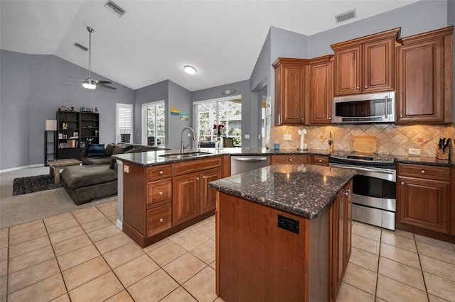 4133 Auston Way, Palm Harbor, FL 34685 - kitchen featuring stainless steel appliances, a sink, open floor plan, light tile patterned flooring, and lofted ceiling