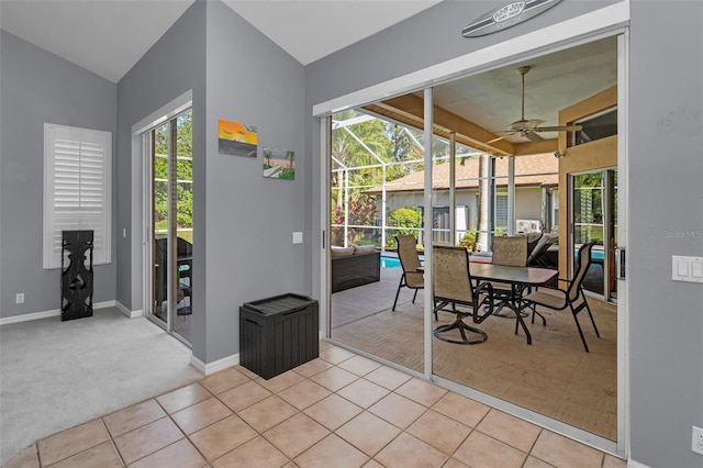 4133 Auston Way, Palm Harbor, FL 34685 - carpeted dining area with ceiling fan, plenty of natural light, tile patterned flooring, baseboards, and vaulted ceiling