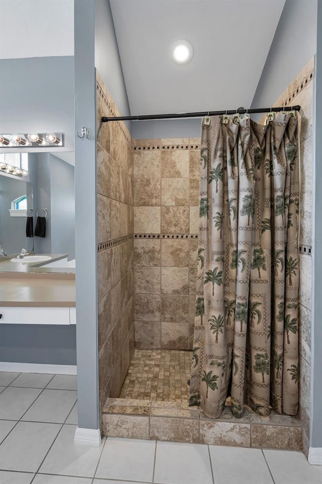 4133 Auston Way, Palm Harbor, FL 34685 - bathroom featuring a tile shower, tile patterned flooring, lofted ceiling, and vanity
