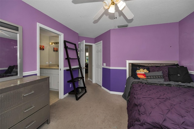 4133 Auston Way, Palm Harbor, FL 34685 - bedroom with light carpet, ensuite bathroom, a ceiling fan, baseboards, and a sink