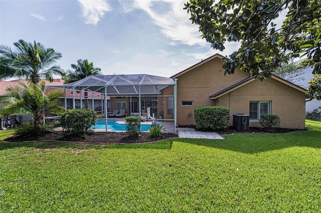 4133 Auston Way, Palm Harbor, FL 34685 - back of property with central air condition unit, stucco siding, a lawn, a patio area, and an outdoor pool