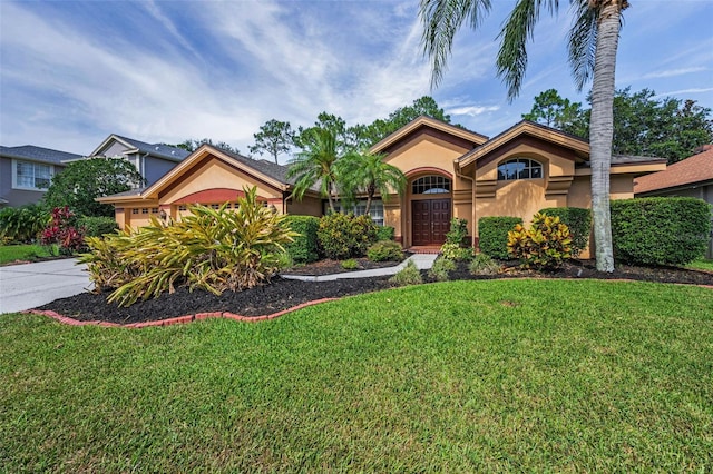 4133 Auston Way, Palm Harbor, FL 34685 - view of front of home with stucco siding, a front yard, a garage, and driveway