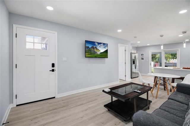 13325 1st St E, Madeira Beach, FL 33708 - living area with light wood-style flooring, recessed lighting, and baseboards