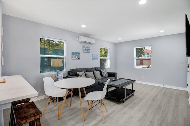 13325 1st St E, Madeira Beach, FL 33708 - living area with a wall unit AC, light wood-type flooring, plenty of natural light, recessed lighting, and baseboards