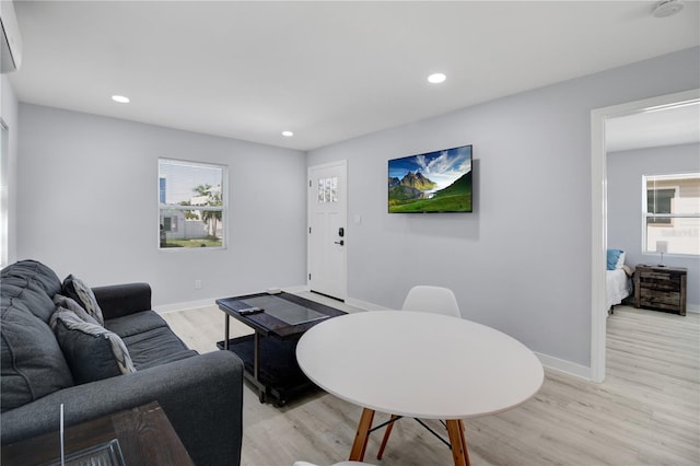 13325 1st St E, Madeira Beach, FL 33708 - living area with light wood-style flooring, recessed lighting, baseboards, and a wall unit AC