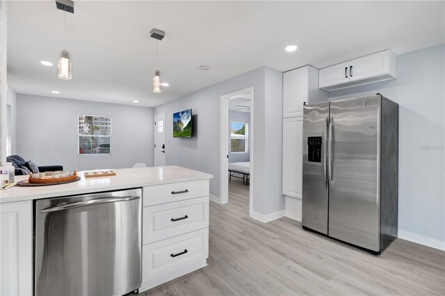 13325 1st St E, Madeira Beach, FL 33708 - kitchen featuring stainless steel appliances, light wood-style flooring, baseboards, white cabinetry, and recessed lighting