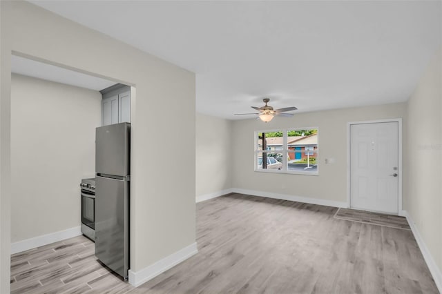 24862 US Highway 19 N Unit 1105, Clearwater, FL 33763 - unfurnished living room with light wood-style floors, ceiling fan, and baseboards