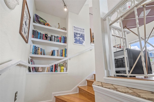 741 Mainsail Dr, Tampa, FL 33602 - staircase featuring rail lighting, baseboards, and wood finished floors