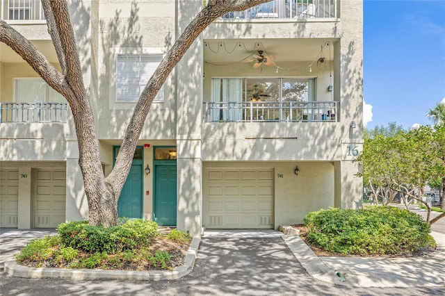 741 Mainsail Dr, Tampa, FL 33602 - view of property featuring a balcony, stucco siding, and a garage
