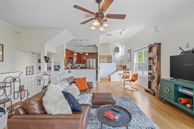 741 Mainsail Dr, Tampa, FL 33602 - living room with rail lighting, a ceiling fan, crown molding, light wood finished floors, and a textured ceiling