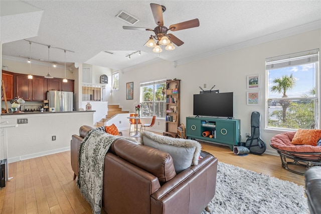 741 Mainsail Dr, Tampa, FL 33602 - living area with track lighting, a ceiling fan, a textured ceiling, light wood-style flooring, and crown molding