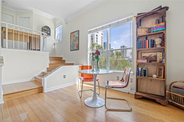 741 Mainsail Dr, Tampa, FL 33602 - dining space with ornamental molding, stairway, wood-type flooring, and a city view