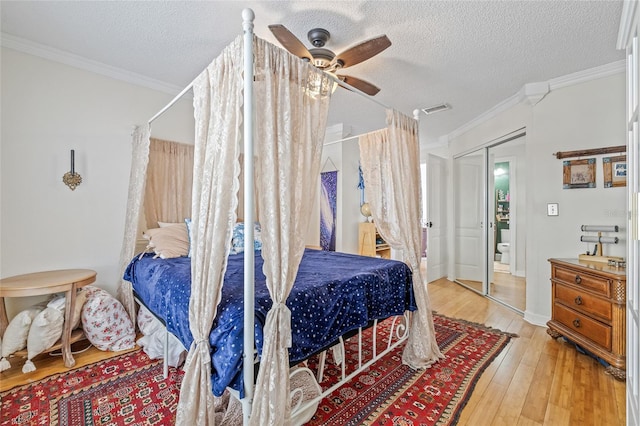 741 Mainsail Dr, Tampa, FL 33602 - bedroom featuring a textured ceiling, hardwood / wood-style flooring, ornamental molding, and a ceiling fan