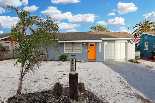 13800 Judy Ave, Hudson, FL 34667 - view of front of home featuring driveway, stucco siding, and a garage