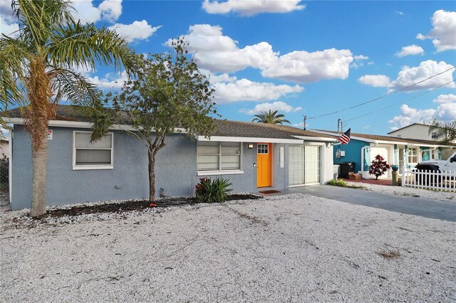 13800 Judy Ave, Hudson, FL 34667 - single story home featuring stucco siding, an attached garage, and driveway