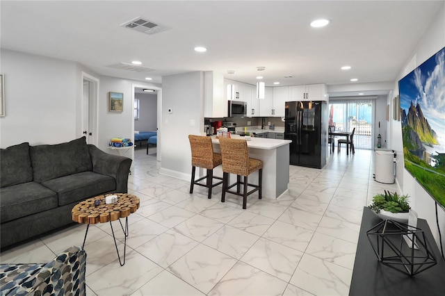 13800 Judy Ave, Hudson, FL 34667 - kitchen with stainless steel appliances, a peninsula, open floor plan, light marble finish flooring, and recessed lighting