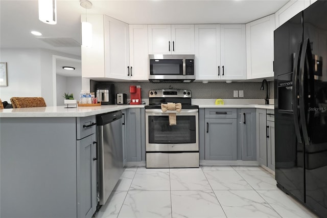 13800 Judy Ave, Hudson, FL 34667 - kitchen with appliances with stainless steel finishes, gray cabinets, light countertops, light marble finish flooring, and recessed lighting