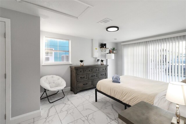 13800 Judy Ave, Hudson, FL 34667 - bedroom with baseboards, light marble finish floors, and attic access