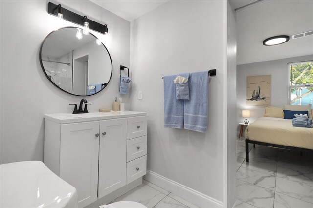 13800 Judy Ave, Hudson, FL 34667 - full bath with marble finish floors, vanity, baseboards, and ensuite bath
