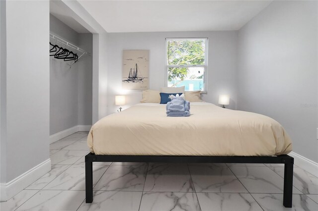 13800 Judy Ave, Hudson, FL 34667 - bedroom featuring marble look tiles and baseboards