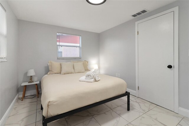 13800 Judy Ave, Hudson, FL 34667 - bedroom featuring light marble finish flooring and baseboards