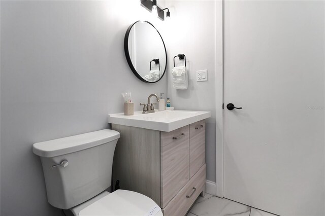 13800 Judy Ave, Hudson, FL 34667 - bathroom featuring marble look tile flooring, toilet, and vanity
