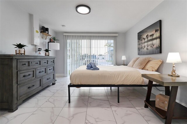 13800 Judy Ave, Hudson, FL 34667 - bedroom with light marble finish floors, access to outside, and baseboards