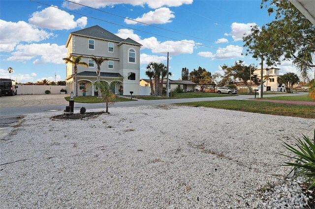 13800 Judy Ave, Hudson, FL 34667 - rear view of house with stucco siding and a porch