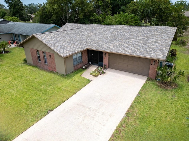 2608 Camille Dr, Palm Harbor, FL 34684 - view of front of house featuring brick siding, a garage, concrete driveway, a front lawn, and a shingled roof