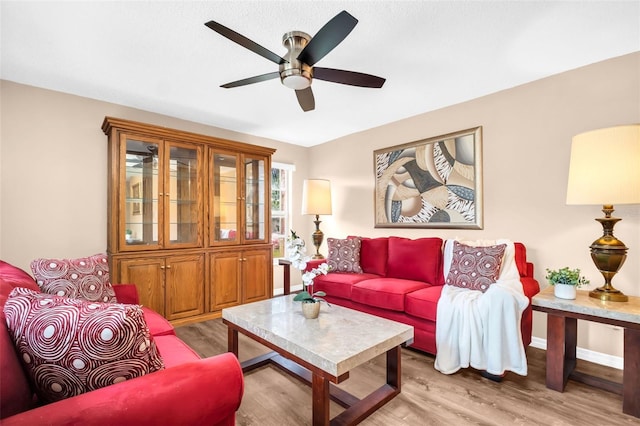 2608 Camille Dr, Palm Harbor, FL 34684 - living area with light wood-type flooring, ceiling fan, and baseboards