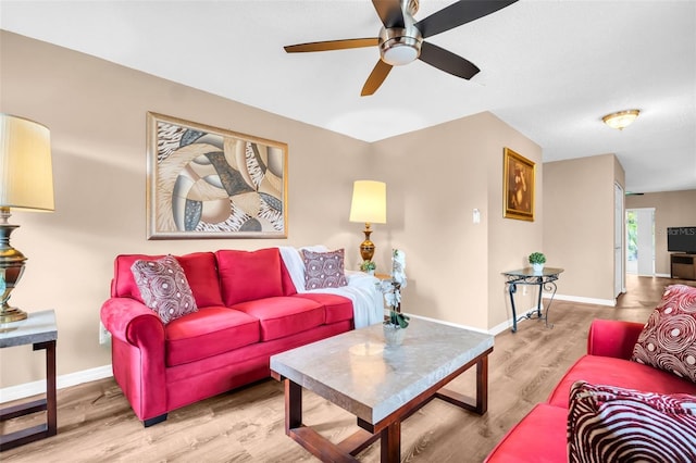 2608 Camille Dr, Palm Harbor, FL 34684 - living area featuring a ceiling fan, wood finished floors, and baseboards