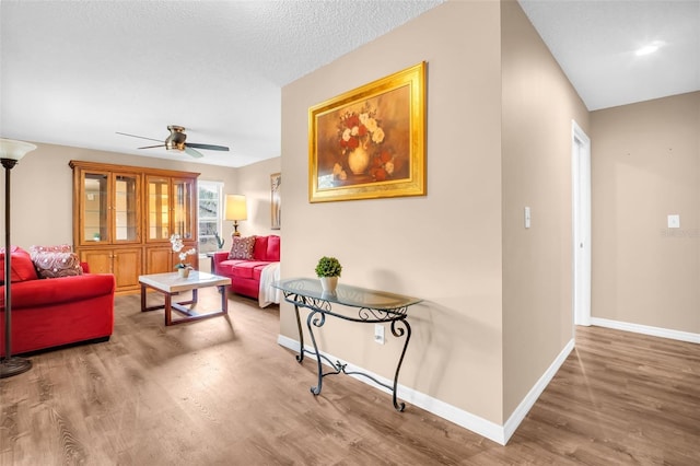 2608 Camille Dr, Palm Harbor, FL 34684 - living area featuring wood finished floors, baseboards, and a ceiling fan