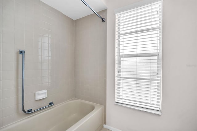 2608 Camille Dr, Palm Harbor, FL 34684 - bathroom with shower / bathtub combination, healthy amount of natural light, and baseboards