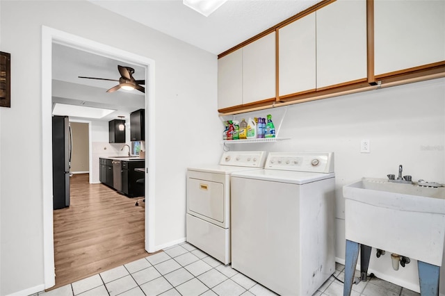 2608 Camille Dr, Palm Harbor, FL 34684 - laundry area with cabinet space, washing machine and dryer, ceiling fan, baseboards, and light tile patterned flooring