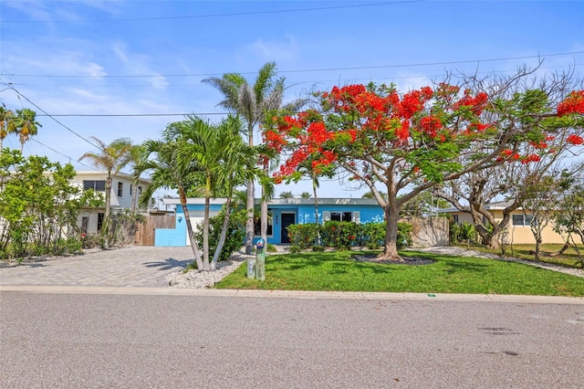 403 Normandy Rd, Madeira Beach, FL 33708 - view of front facade featuring driveway, a front yard, and a garage