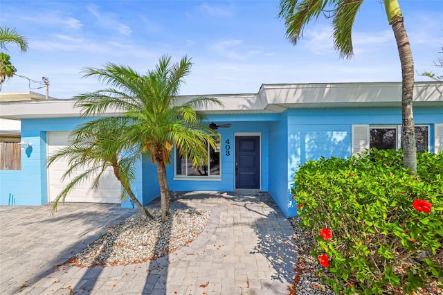 403 Normandy Rd, Madeira Beach, FL 33708 - entrance to property with an attached garage and driveway