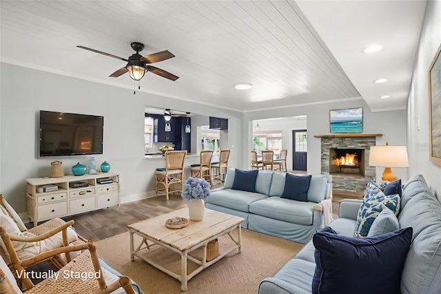 403 Normandy Rd, Madeira Beach, FL 33708 - living area with a ceiling fan, wood finished floors, healthy amount of natural light, crown molding, and baseboards
