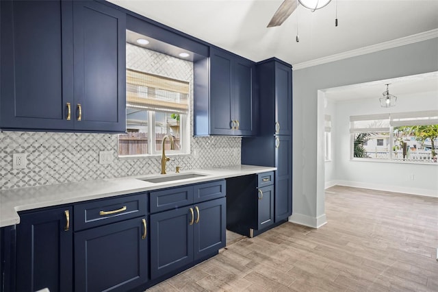 403 Normandy Rd, Madeira Beach, FL 33708 - kitchen featuring a sink, blue cabinetry, ceiling fan, light countertops, and ornamental molding
