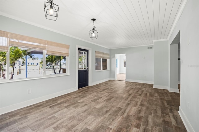 403 Normandy Rd, Madeira Beach, FL 33708 - unfurnished living room with crown molding, plenty of natural light, wood finished floors, and baseboards