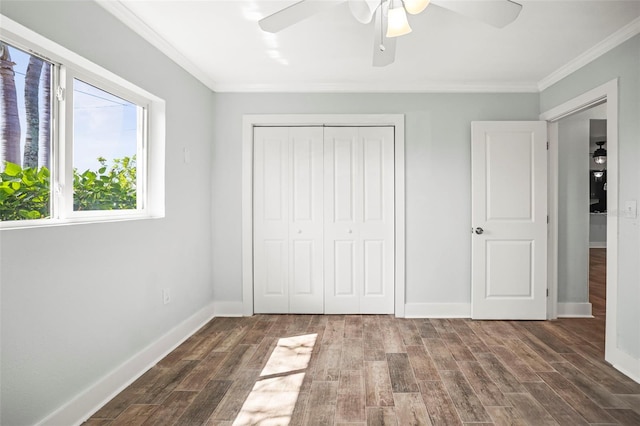403 Normandy Rd, Madeira Beach, FL 33708 - unfurnished bedroom featuring crown molding, wood finished floors, a closet, baseboards, and ceiling fan