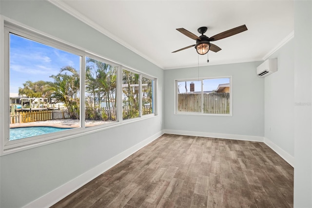 403 Normandy Rd, Madeira Beach, FL 33708 - spare room featuring an AC wall unit, baseboards, wood finished floors, a ceiling fan, and ornamental molding