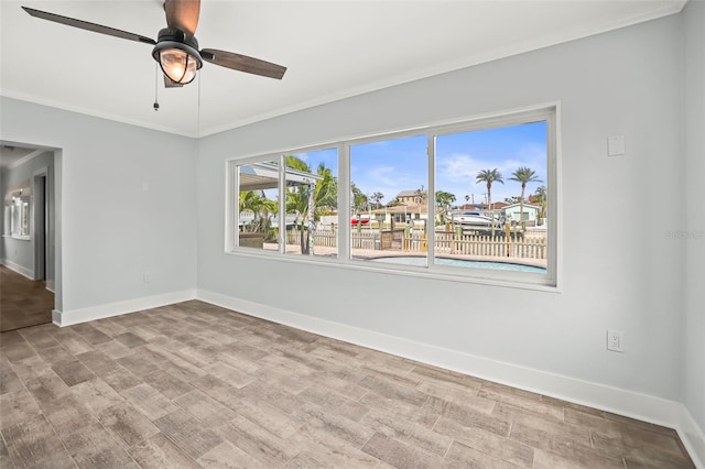403 Normandy Rd, Madeira Beach, FL 33708 - spare room featuring crown molding, baseboards, a ceiling fan, and wood finished floors