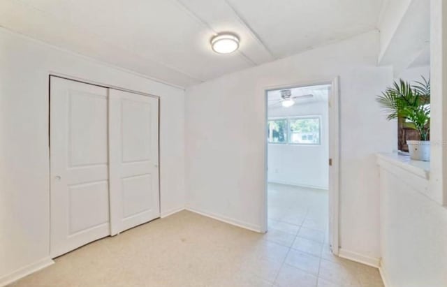 7313 Royal Palm Dr, New Port Richey, FL 34652 - unfurnished bedroom with baseboards, light tile patterned floors, and a closet