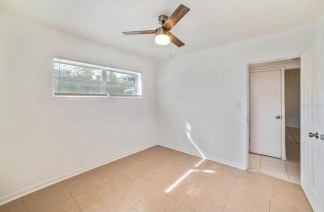 7313 Royal Palm Dr, New Port Richey, FL 34652 - unfurnished room featuring a ceiling fan, light tile patterned flooring, and baseboards