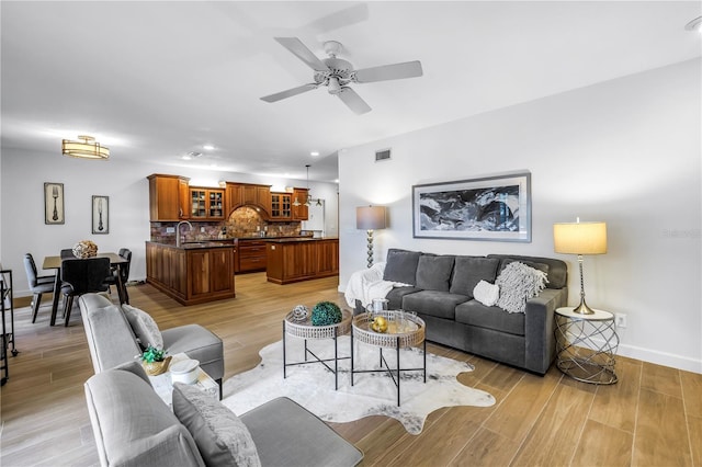 8127 Siquita Dr NE, Saint Petersburg, FL 33702 - living area featuring baseboards, ceiling fan, light wood-style flooring, and recessed lighting