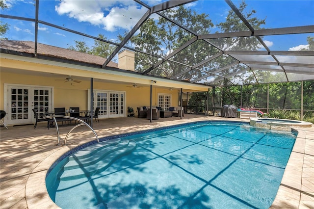 8127 Siquita Dr NE, Saint Petersburg, FL 33702 - view of swimming pool with french doors, ceiling fan, outdoor lounge area, a pool with connected hot tub, and a patio area